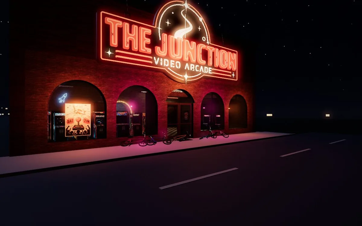 THE JUNCTION video arcade glowing in red neon on a dark street at night